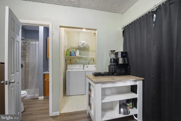 a kitchen with a refrigerator and a stove top oven