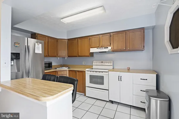 a kitchen with a stove cabinets and a refrigerator