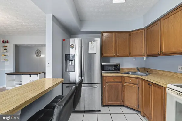a kitchen with a sink stove and refrigerator