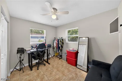 a view of a workspace with furniture and a window