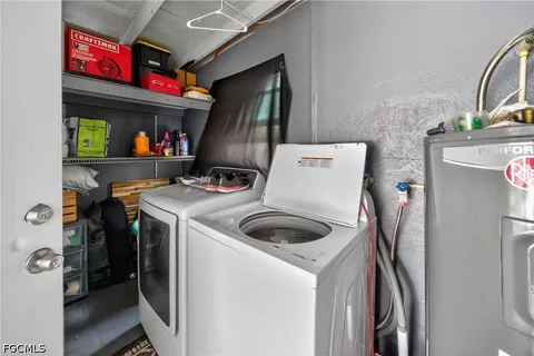 a utility room with dryer washer and storage