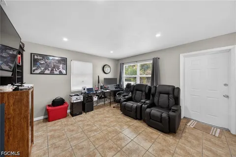 a living room with furniture a couch and a flat screen tv