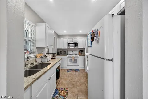 a kitchen with refrigerator a sink and cabinets