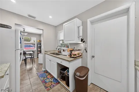 a kitchen with a sink cabinets and stove top oven