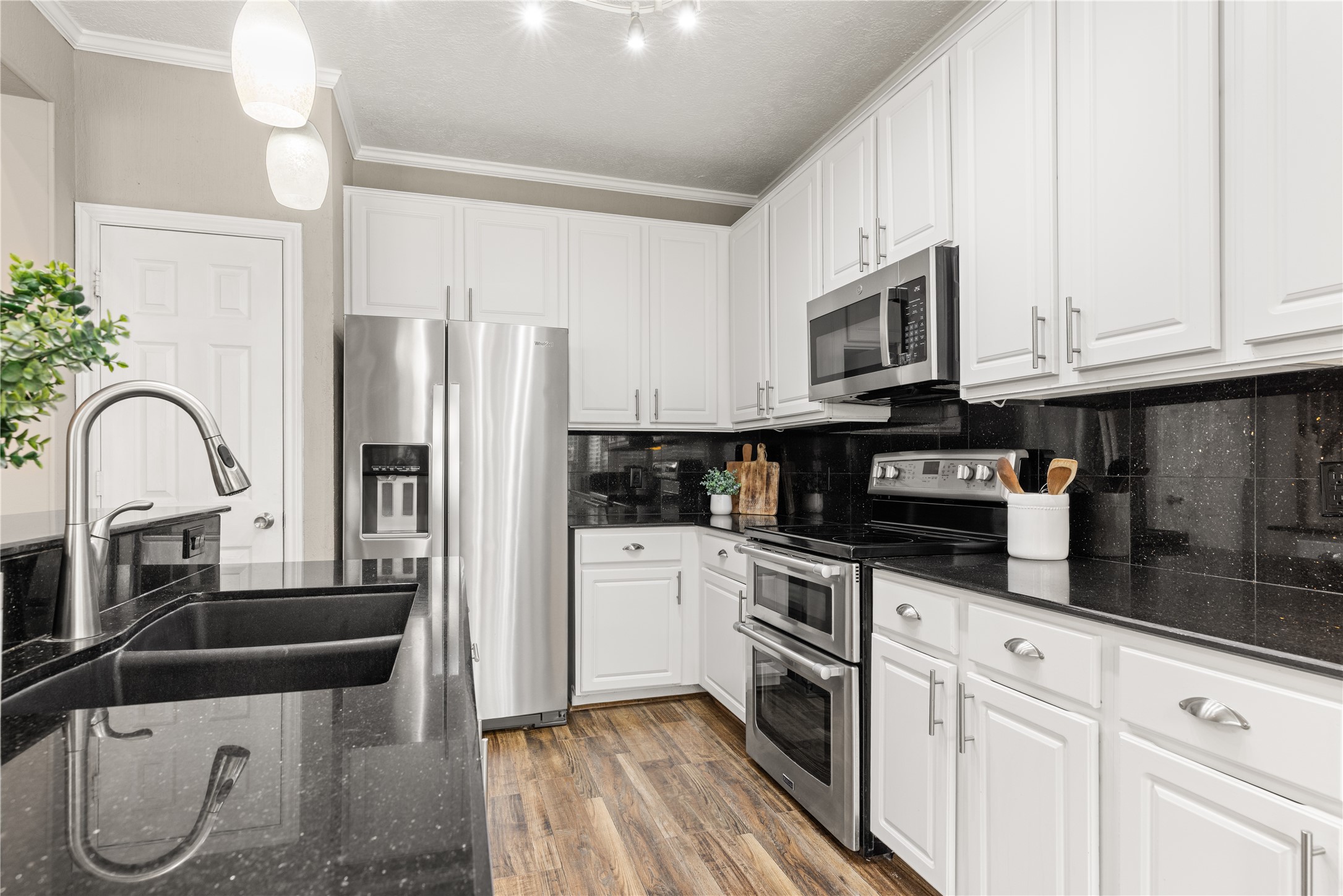 20823 Water Point Trail Humble, TX 77346 - Photo 13 of 43 a kitchen with stainless steel appliances granite countertop a stove a sink and a refrigerator
