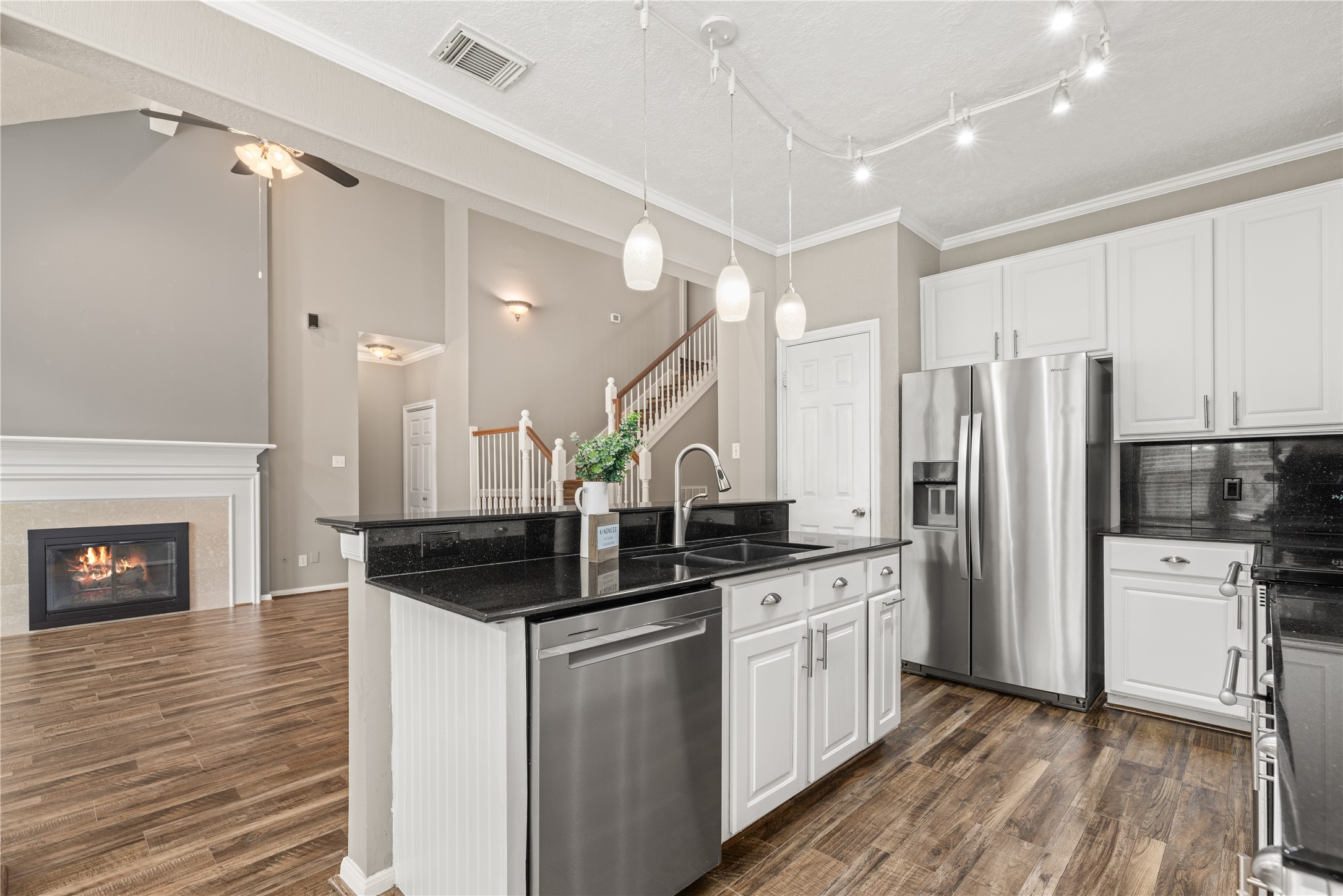 20823 Water Point Trail Humble, TX 77346 - Photo 14 of 43 a kitchen with granite countertop a sink cabinets stainless steel appliances and a wooden floor