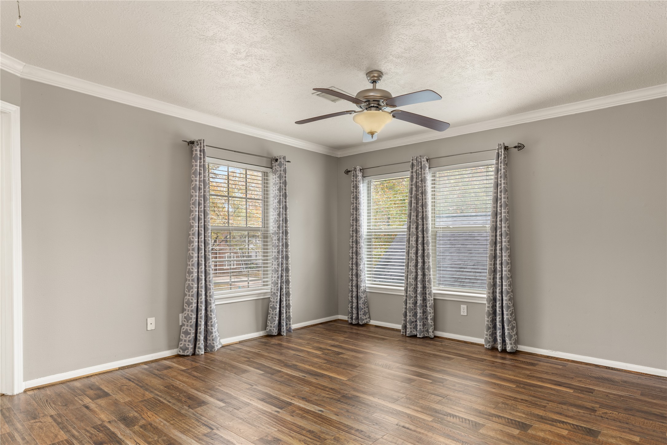 20823 Water Point Trail Humble, TX 77346 - Photo 28 of 43 an empty room with wooden floor and windows with curtains
