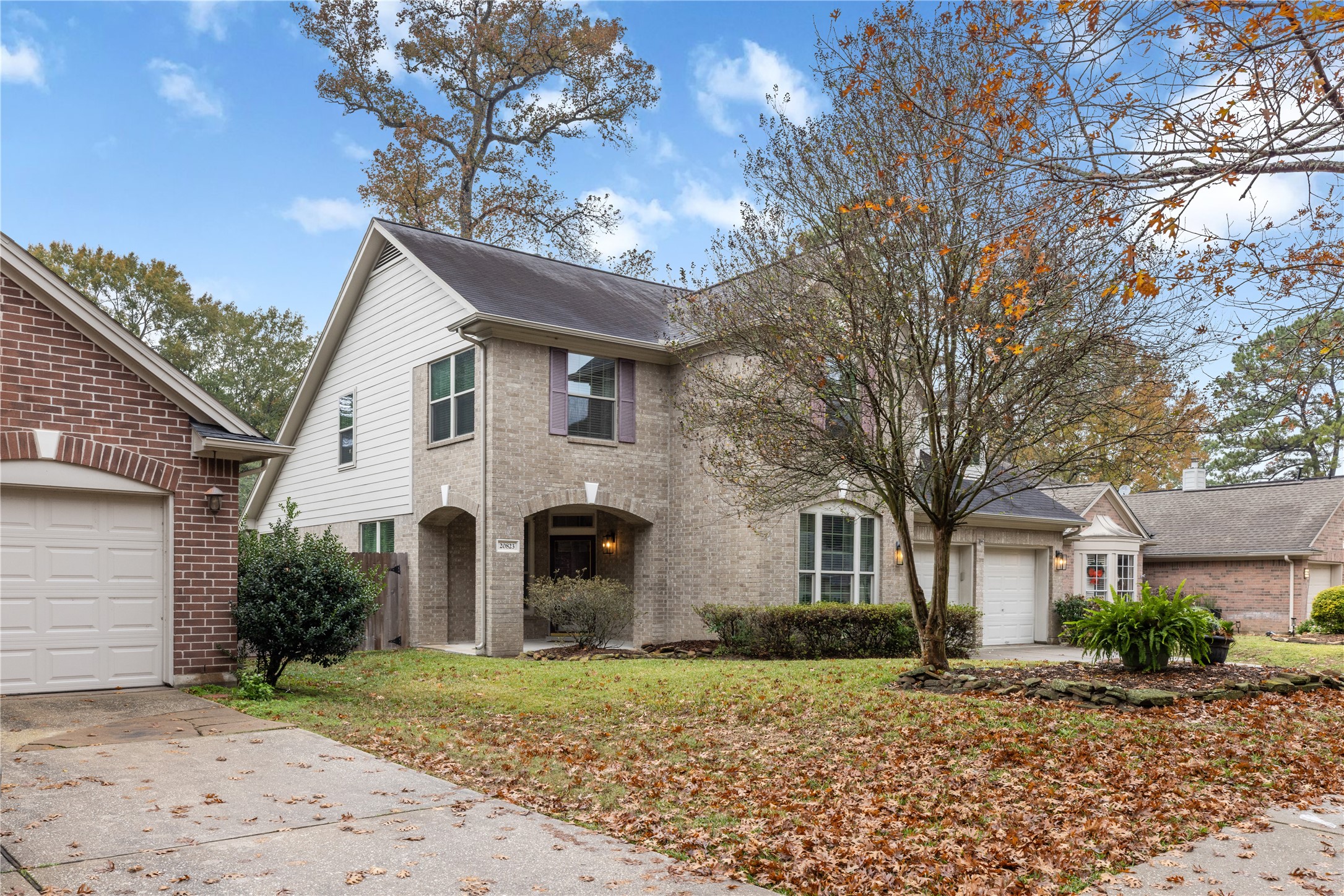 20823 Water Point Trail Humble, TX 77346 - Photo 3 of 43 a view of a white house with a yard and large tree