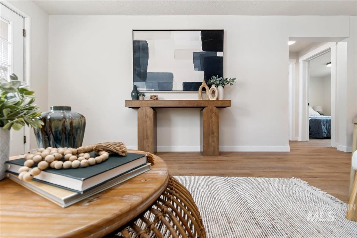 3005 West Hester Street Boise, ID 83702 - Photo 26 of 32 Bright interior featuring wood-finish flooring, white walls, and a substantial wooden console table