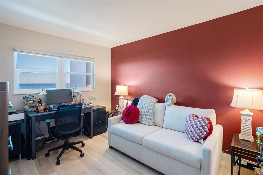 9397 Midnight Pass Road, Unit 905 Sarasota, FL 34242 - Photo 11 of 37 a living room with furniture and a work place area