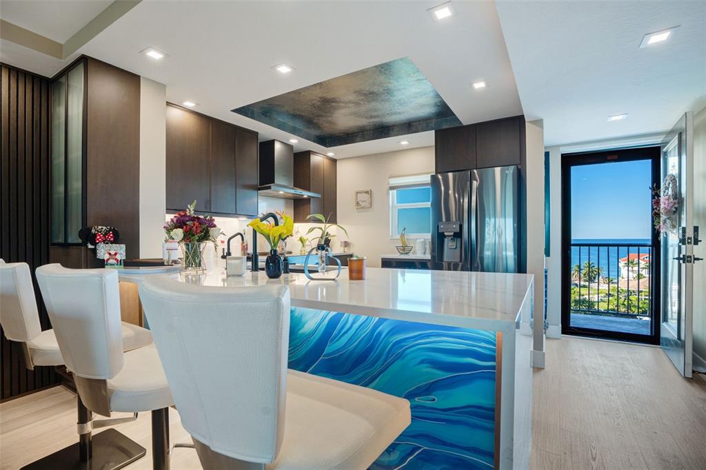 9397 Midnight Pass Road, Unit 905 Sarasota, FL 34242 - Photo 2 of 37 a view of a dining room with furniture wooden floor and kitchen view
