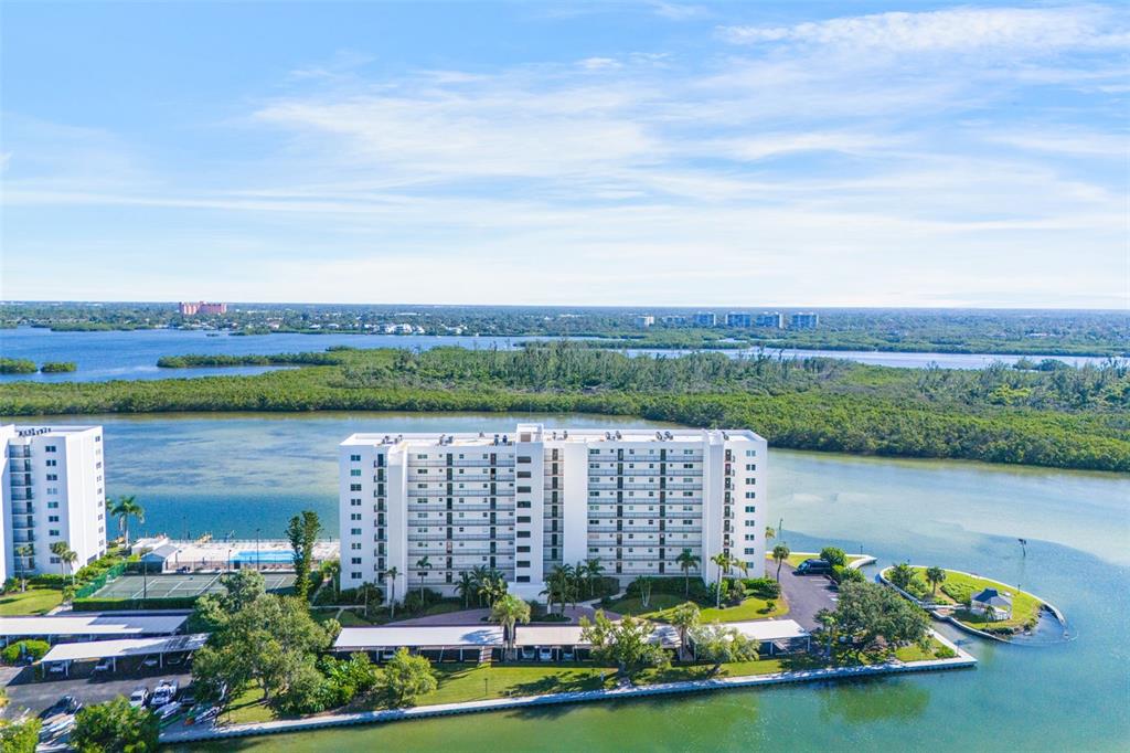 9397 Midnight Pass Road, Unit 905 Sarasota, FL 34242 - Photo 24 of 37 an aerial view of a house with a garden and lake view