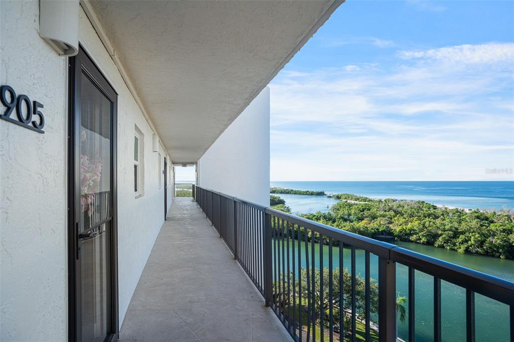 9397 Midnight Pass Road, Unit 905 Sarasota, FL 34242 - Photo 29 of 37 a view of a balcony with wooden floor