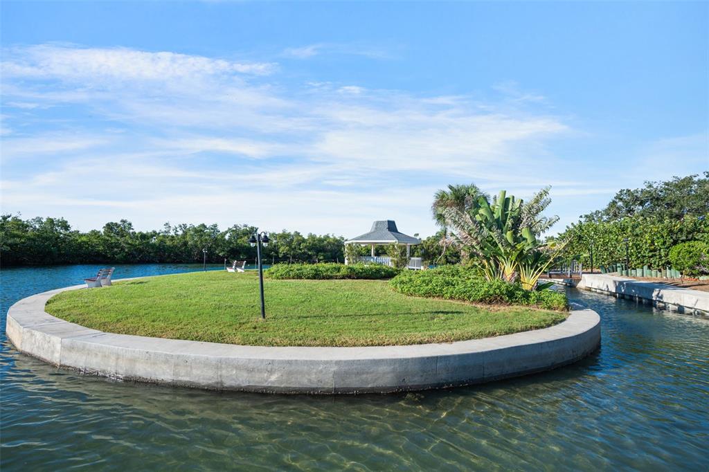 9397 Midnight Pass Road, Unit 905 Sarasota, FL 34242 - Photo 31 of 37 a view of a swimming pool with a yard