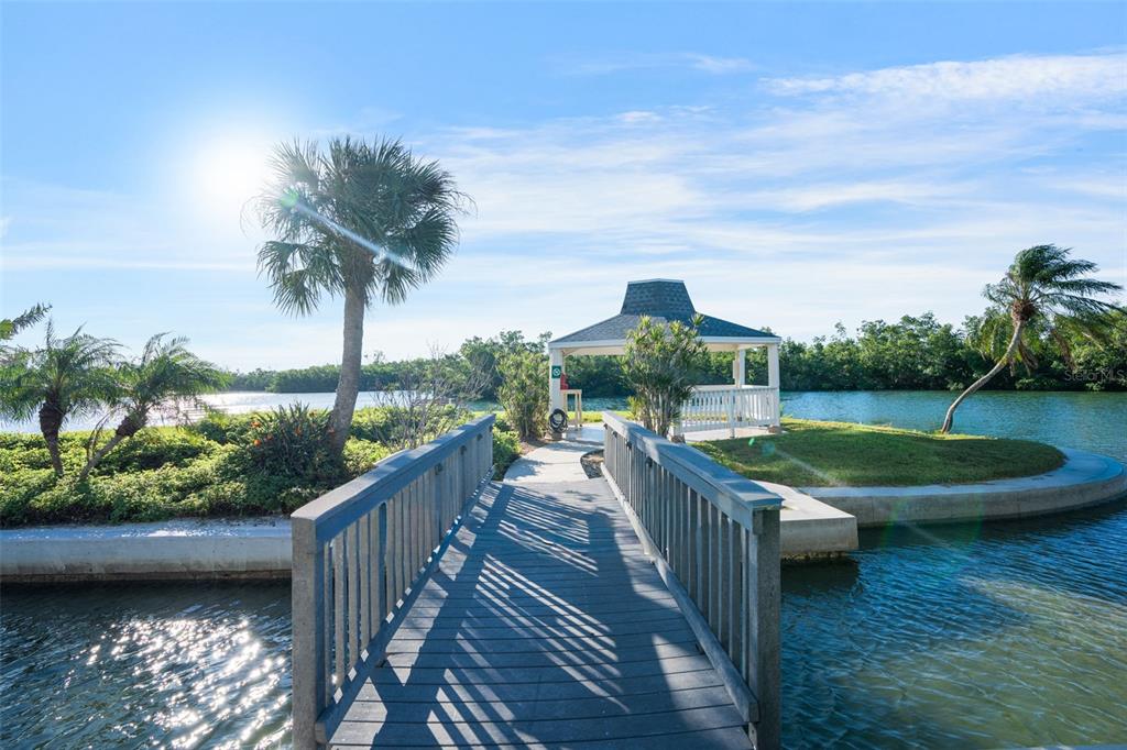9397 Midnight Pass Road, Unit 905 Sarasota, FL 34242 - Photo 32 of 37 a view of a house with porch yard and potted plants