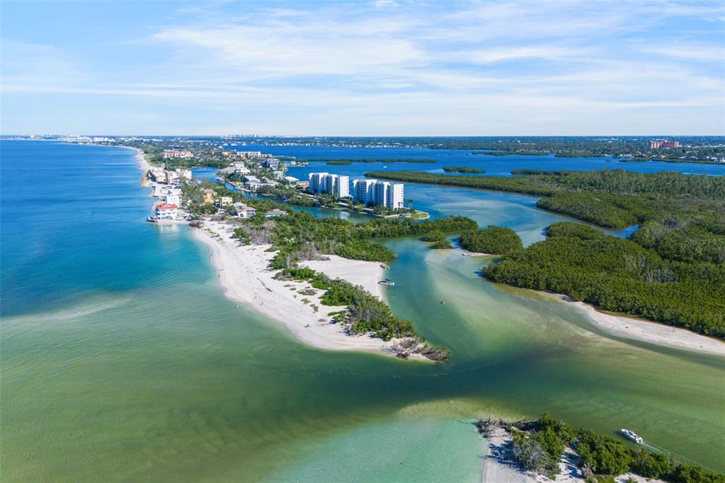9397 Midnight Pass Road, Unit 905 Sarasota, FL 34242 - Photo 33 of 37 a view of a lake with a city