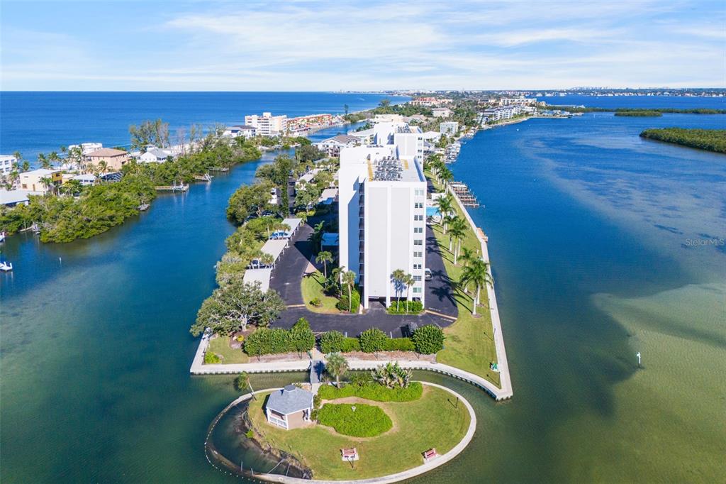 9397 Midnight Pass Road, Unit 905 Sarasota, FL 34242 - Photo 34 of 37 a picture of a table and chairs in the patio
