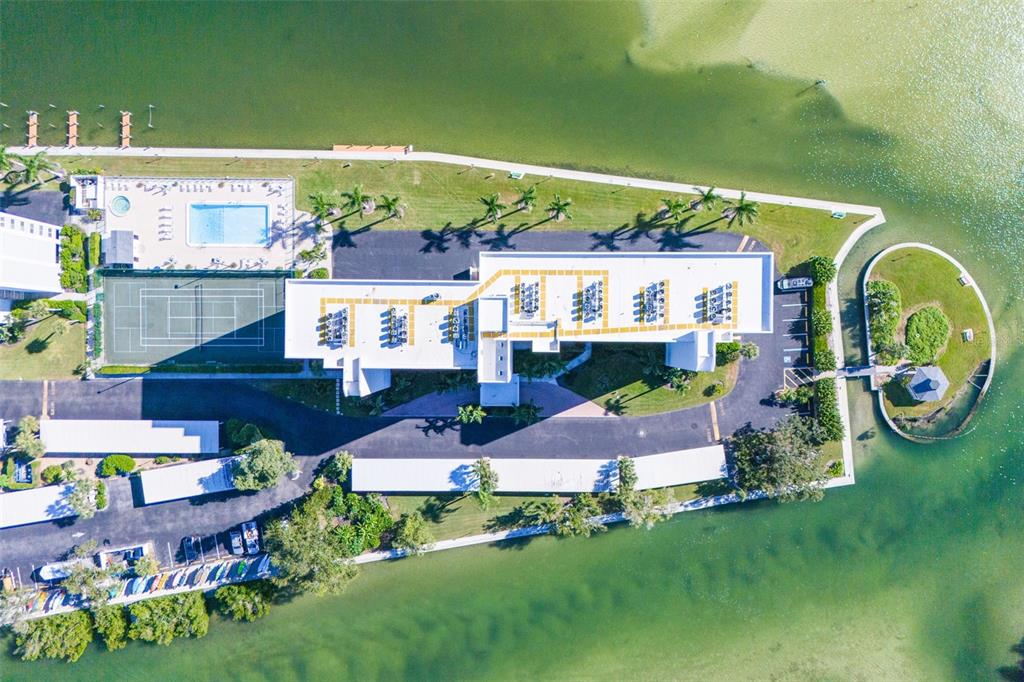 9397 Midnight Pass Road, Unit 905 Sarasota, FL 34242 - Photo 36 of 37 a front view of a house with garden