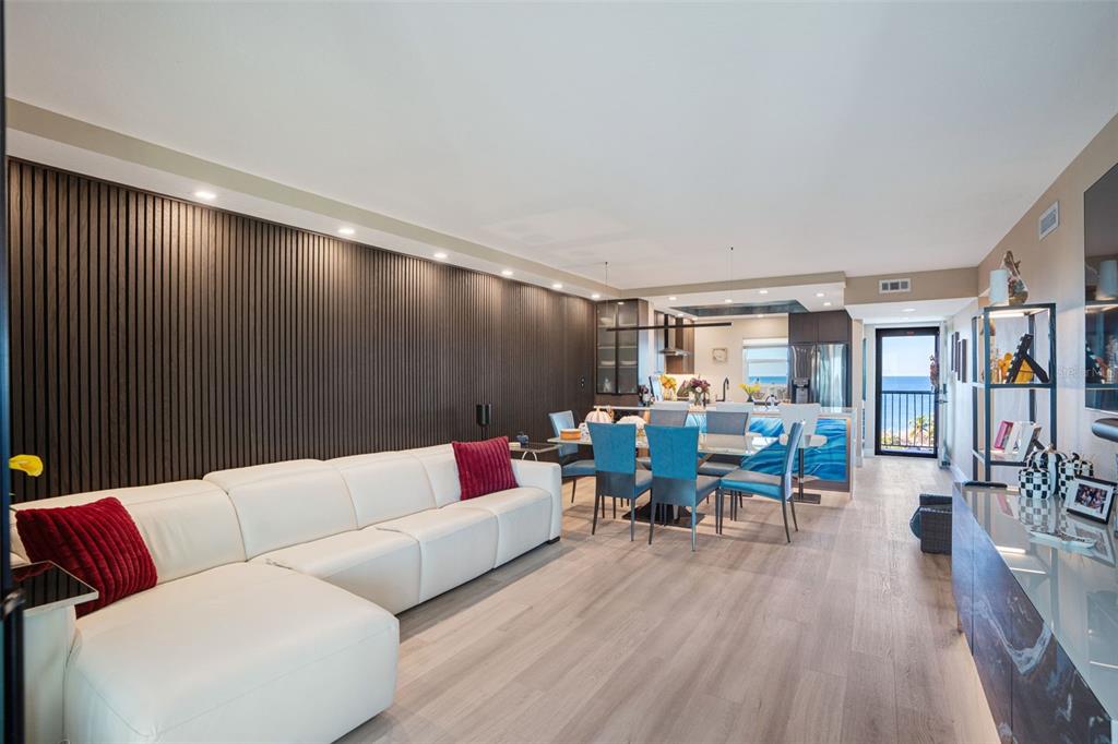 9397 Midnight Pass Road, Unit 905 Sarasota, FL 34242 - Photo 5 of 37 a living room with furniture and a wooden floor