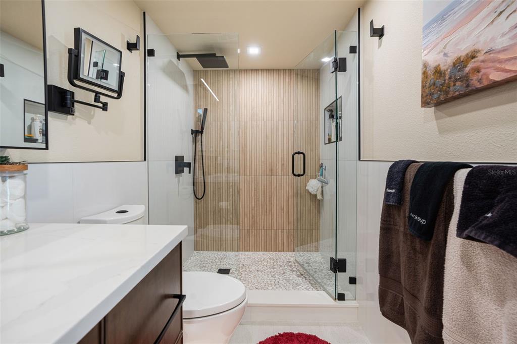 9397 Midnight Pass Road, Unit 905 Sarasota, FL 34242 - Photo 9 of 37 a bathroom with a sink toilet and shower