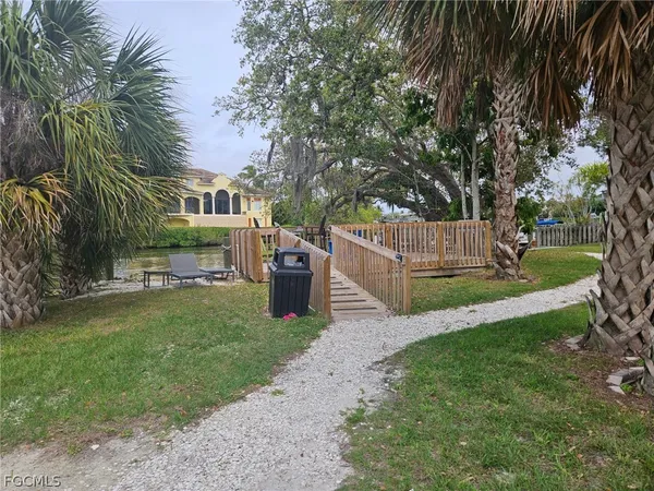 a view of a garden with wooden fence