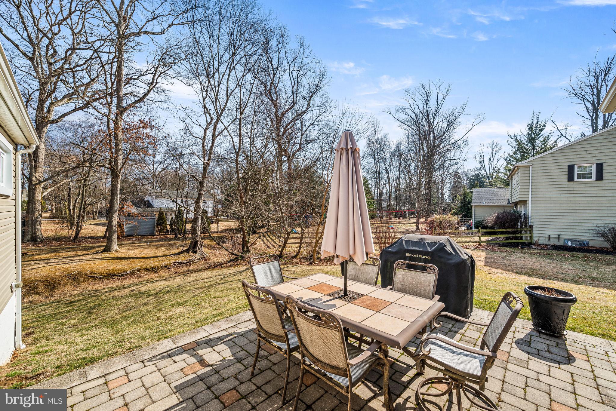 408 Scott Lane Wallingford, PA 19086 - Photo 33 of 39 a view of a patio with a dining table and chairs with wooden floor and fence