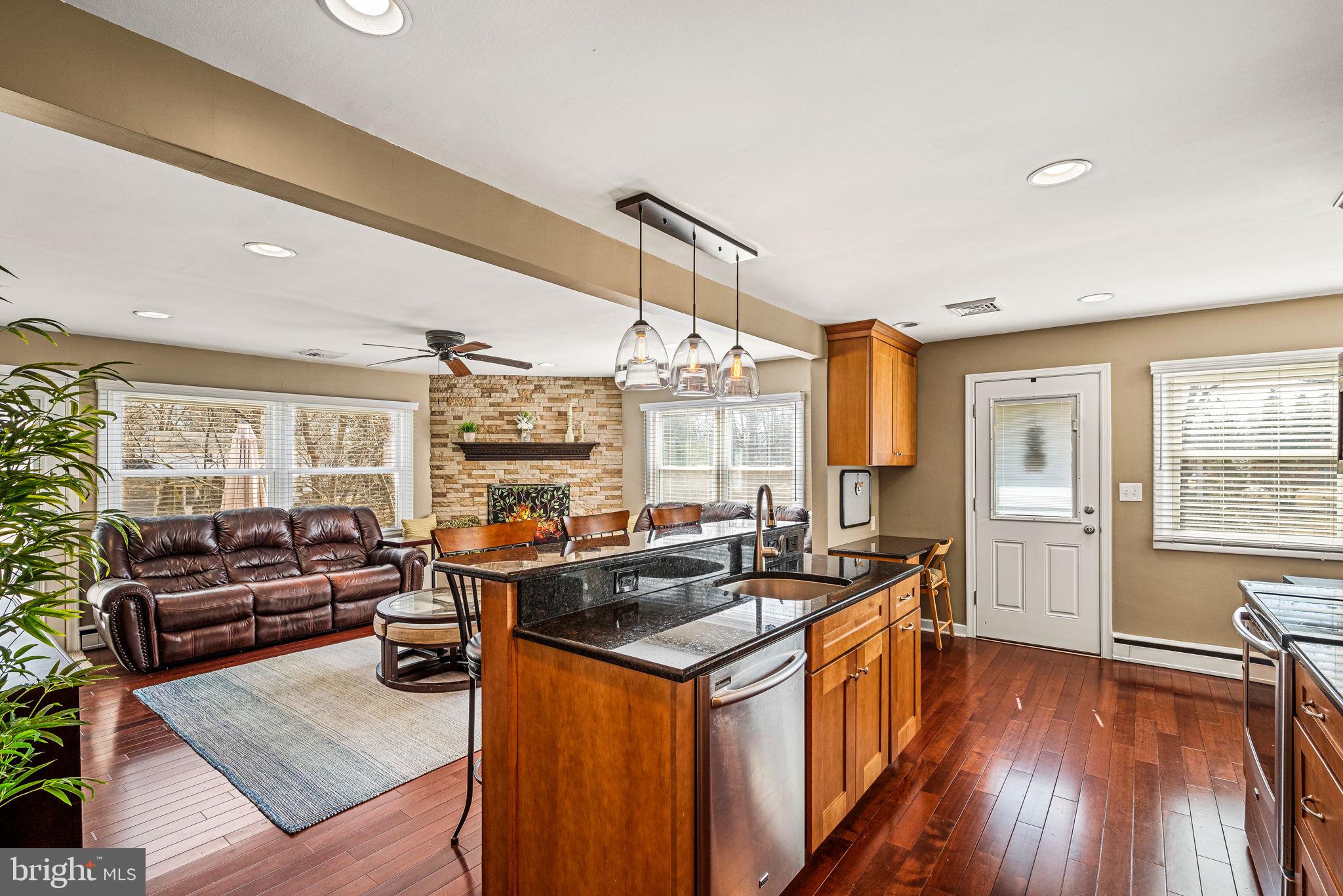 408 Scott Lane Wallingford, PA 19086 - Photo 10 of 39 a kitchen with stainless steel appliances granite countertop a sink stove and wooden cabinets