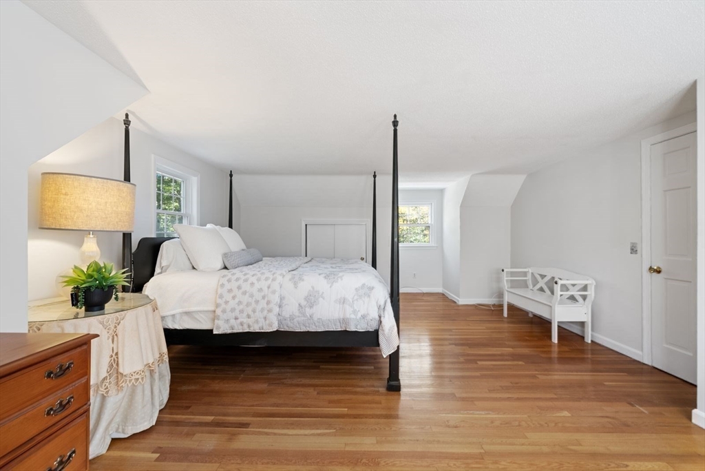 43 Canterbury Road Yarmouth, MA 02675 - Photo 13 of 25 a bedroom with a bed lamps and wooden floor