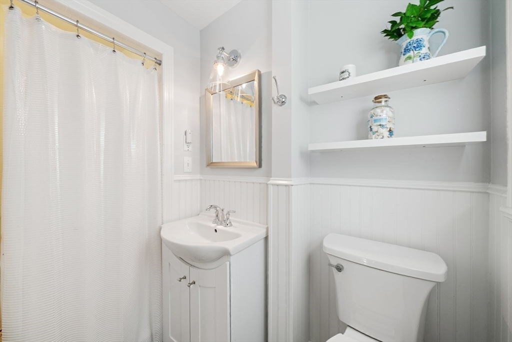 43 Canterbury Road Yarmouth, MA 02675 - Photo 21 of 25 a bathroom with a sink a toilet and a mirror