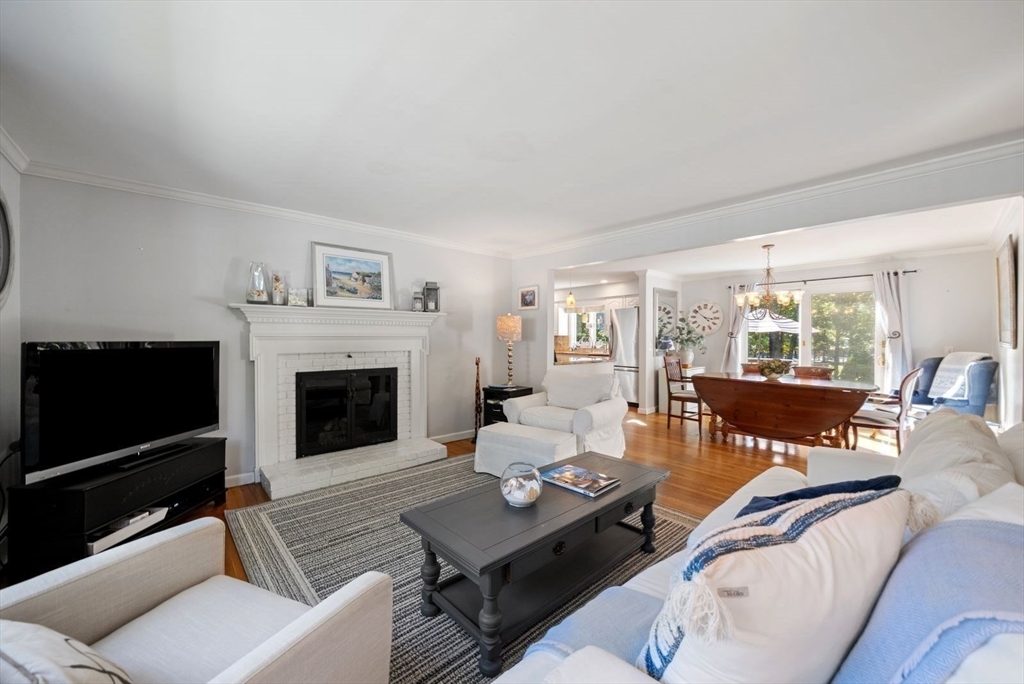 43 Canterbury Road Yarmouth, MA 02675 - Photo 7 of 25 a living room with furniture a flat screen tv and a fireplace