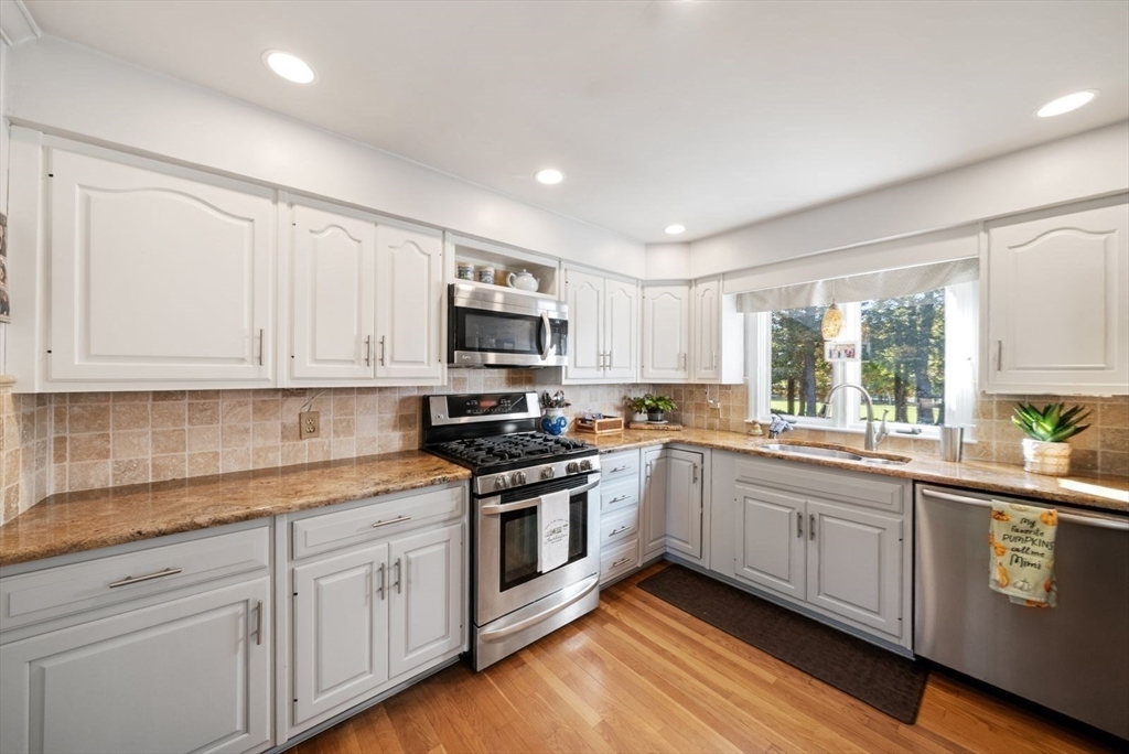 43 Canterbury Road Yarmouth, MA 02675 - Photo 9 of 25 a kitchen with sink a microwave and cabinets