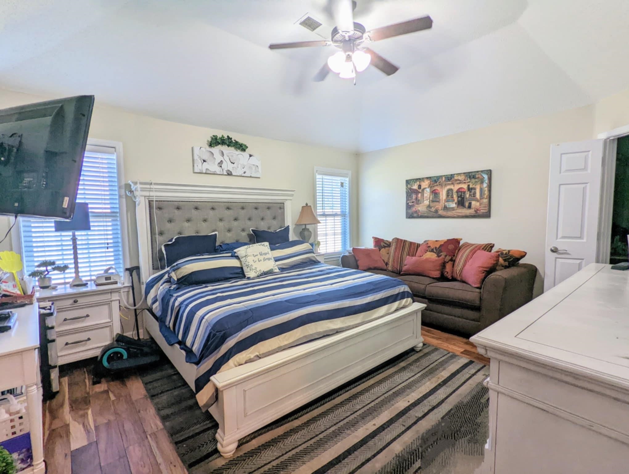 6894 Finch Road Memphis, TN 38141 - Photo 7 of 11 a bedroom with a bed and a chandelier