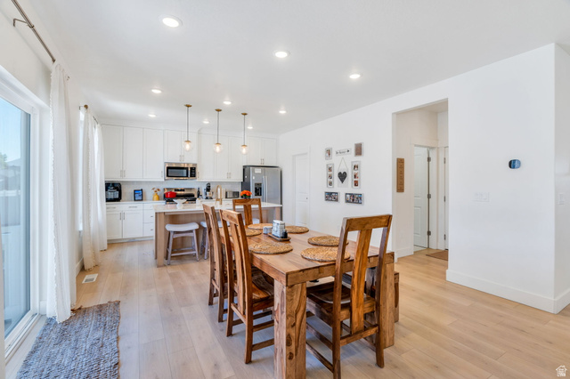 2664 West Maple Street Mapleton, UT 84664 - Photo 13 of 49 Contemporary kitchen and dining area featuring light wood-finish flooring, recessed lighting, and white walls