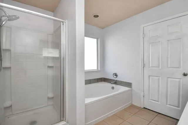 a white bath tub sitting next to a shower