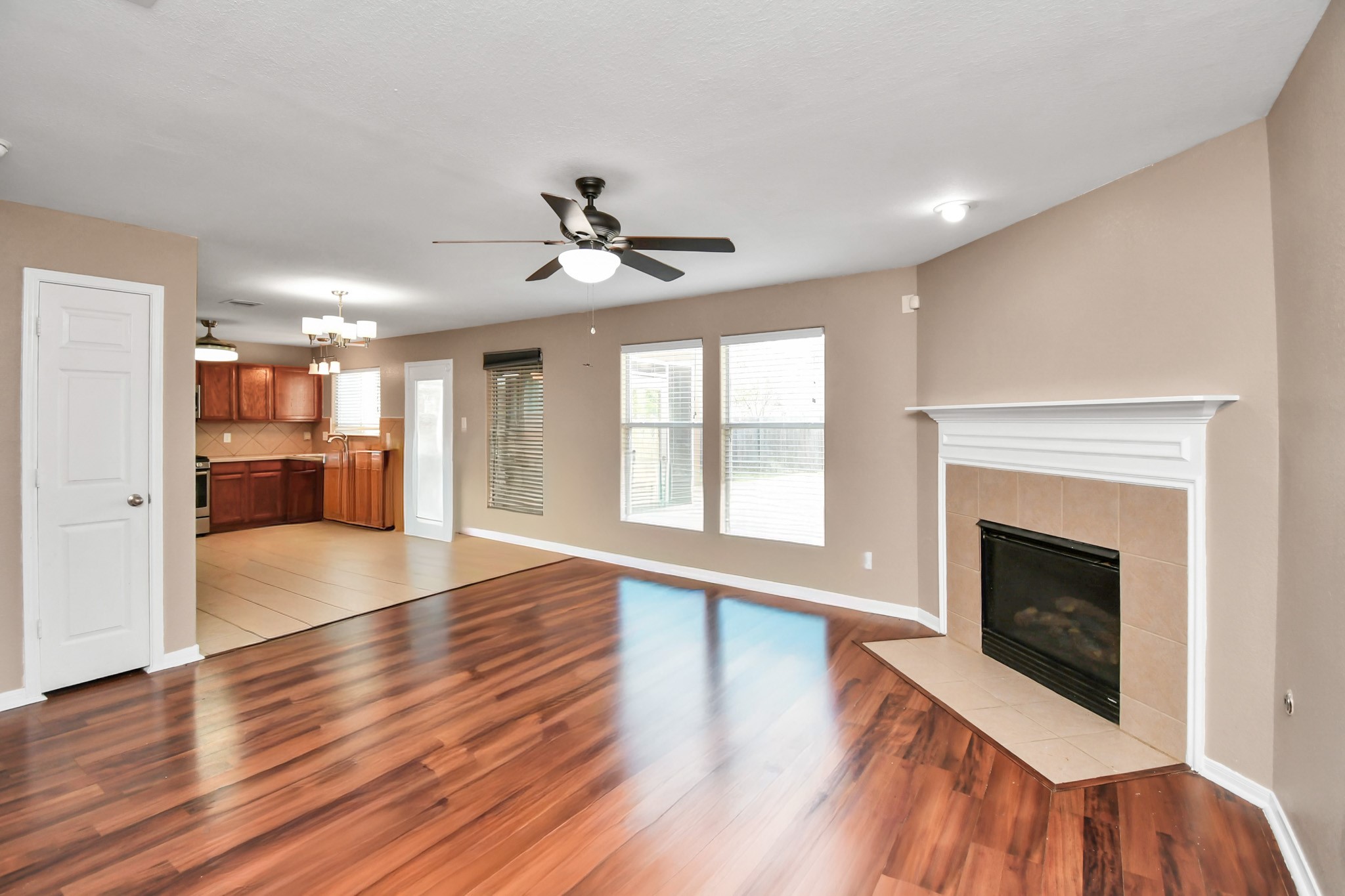 1118 Desert Palms Lane Rosenberg, TX 77471 - Photo 4 of 28 a view of a livingroom with wooden floor and a kitchen