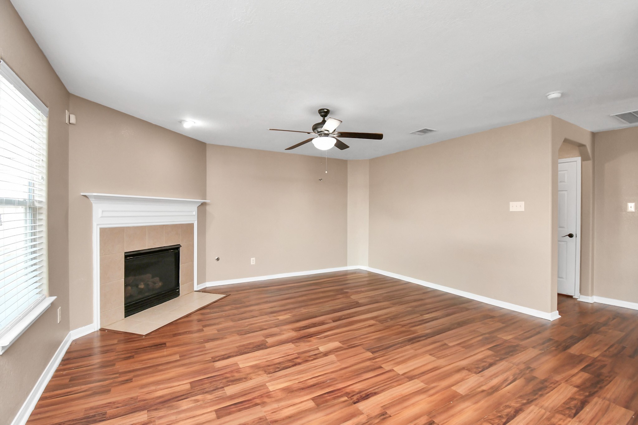 1118 Desert Palms Lane Rosenberg, TX 77471 - Photo 5 of 28 a view of an empty room with wooden floor fireplace and a window