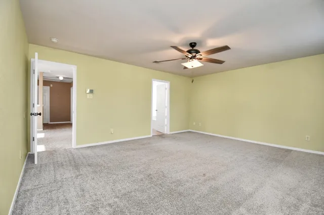 a view of an empty room with a ceiling fan