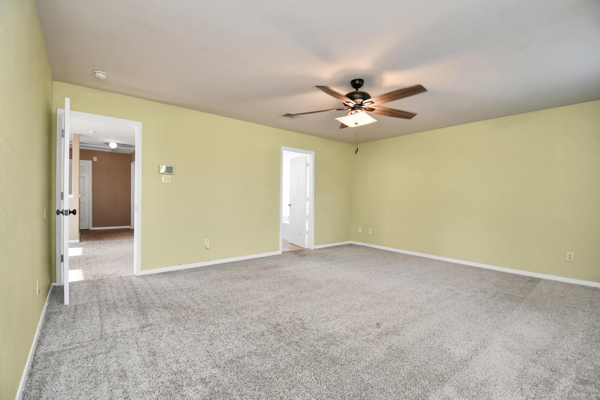 1118 Desert Palms Lane Rosenberg, TX 77471 - Photo 9 of 28 a view of an empty room with a ceiling fan