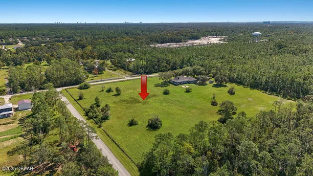 an aerial view of residential houses with outdoor space and swimming pool
