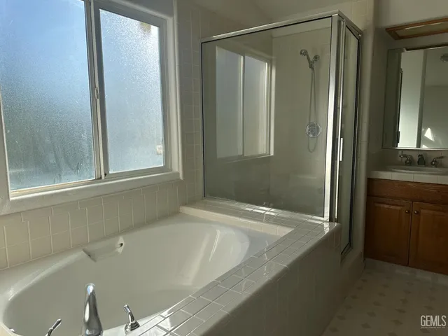 a bath tub sitting in a bathroom next to a window