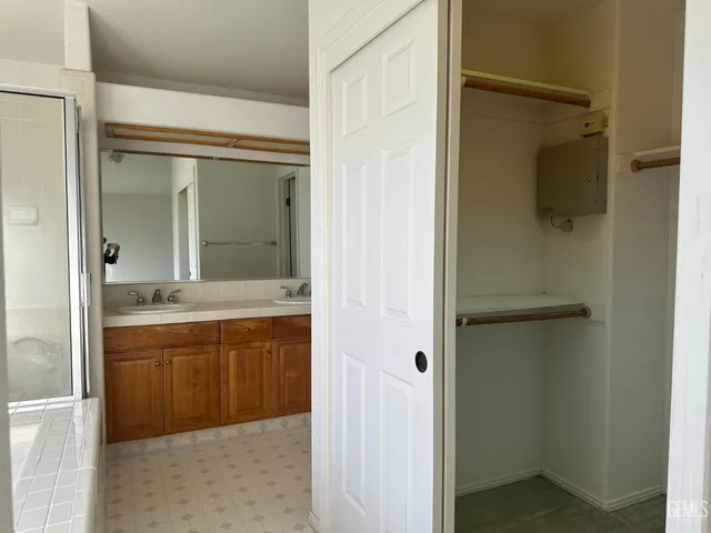 a bathroom with a shower and a sink