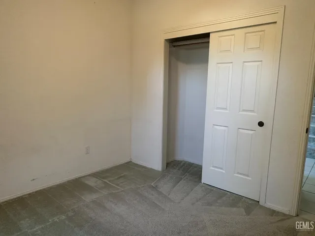 an empty room with closet area