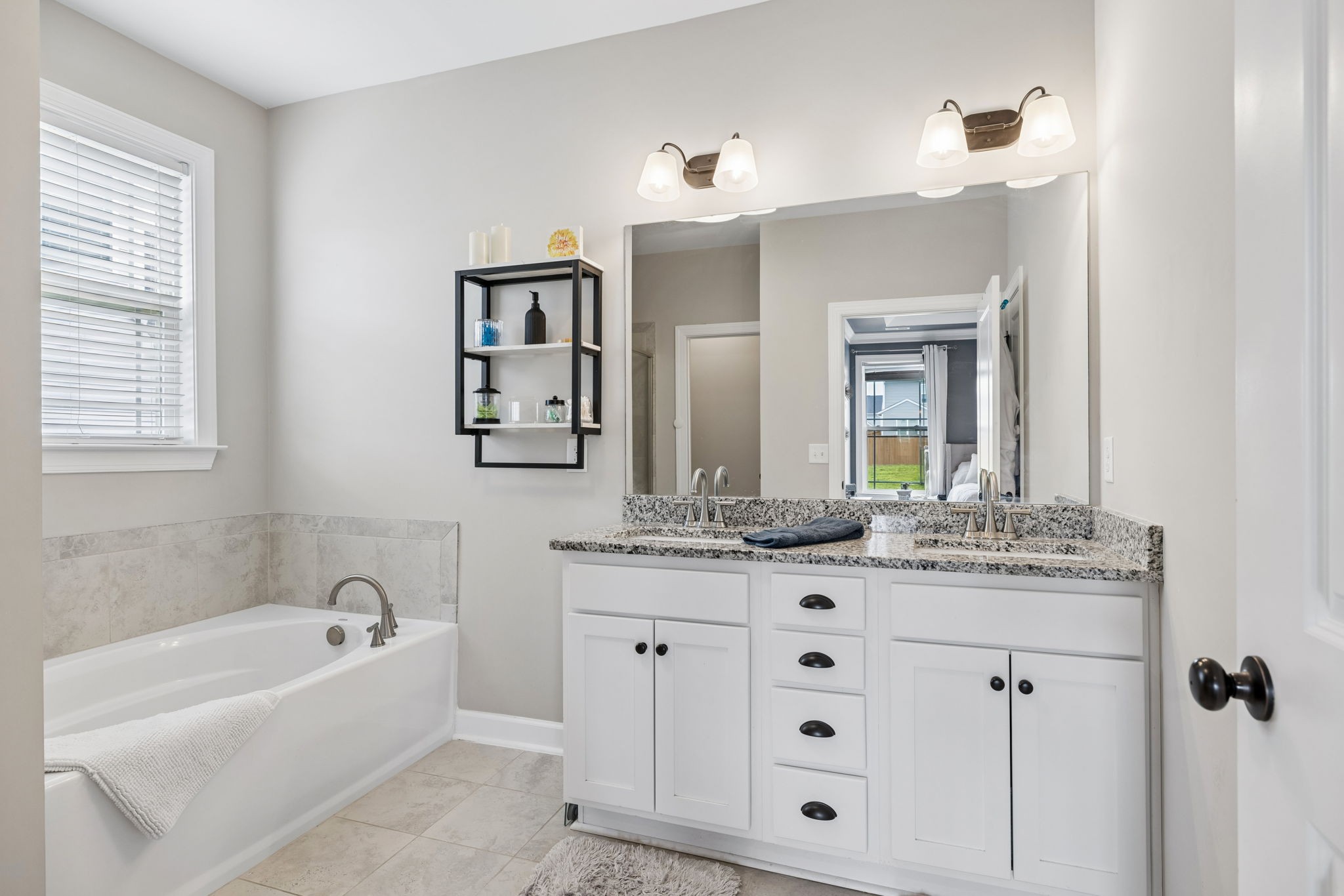 1002 Garrison Way Spring Hill, TN 37174 - Photo 44 of 63 a bathroom with a granite countertop sink mirror and bathtub