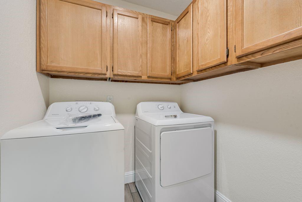 219 West Rochelle Road Irving, TX 75062 - Photo 13 of 29 Dedicated laundry space featuring upper wood cabinetry and light-colored walls