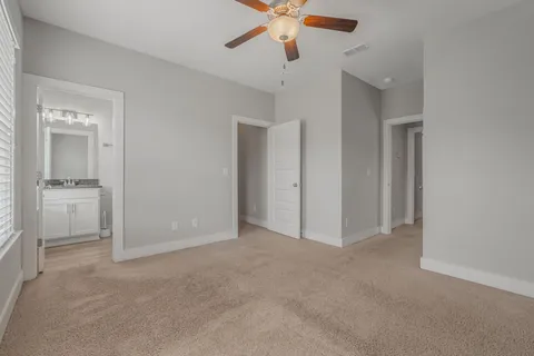 a view of an empty room with a ceiling fan