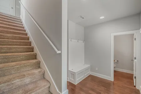 a view of entryway with wooden floor and stairs