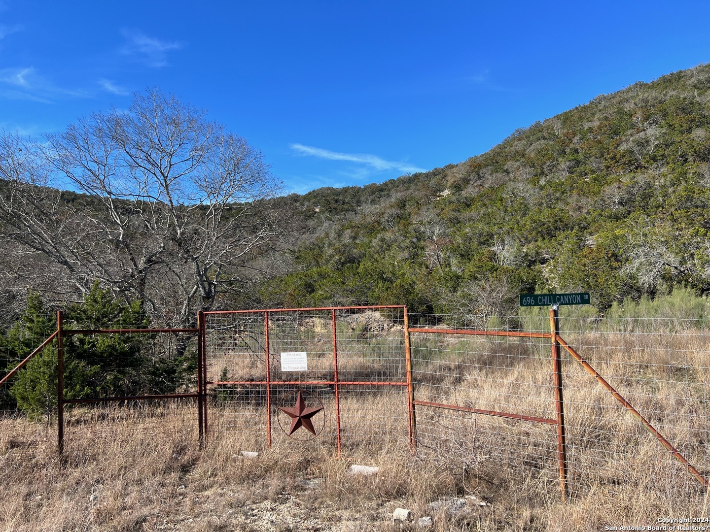 696 Chili Canyon Road Tarpley, TX 78883 - Photo 6 of 18 a backyard of a house with table and chairs