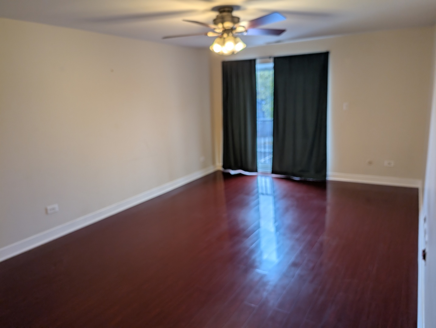 960 South River Road, Unit 208 Des Plaines, IL 60016 - Photo 5 of 11 a view of an empty room with window and wooden floor