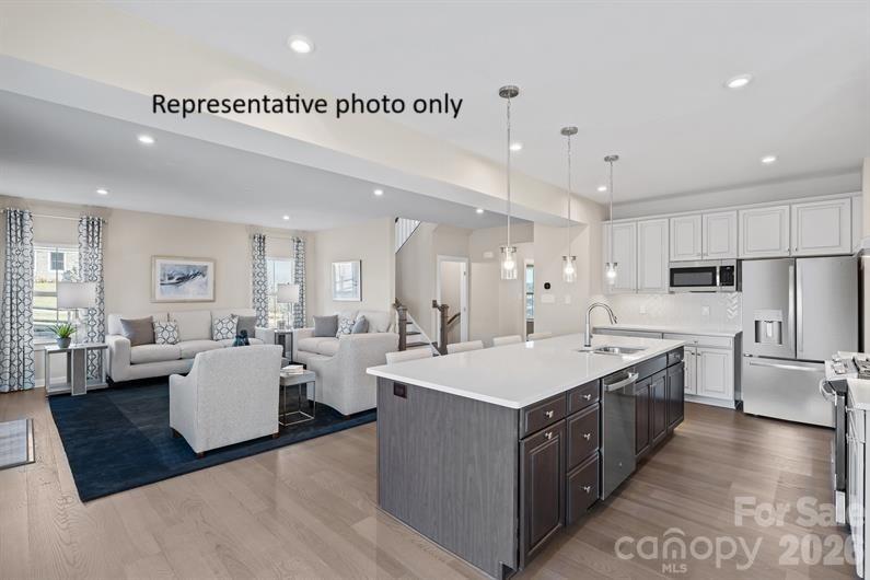 1025 Black Bear Road, Unit 3261 Indian Trail, NC 28079 - Photo 2 of 13 a large white kitchen with a large counter top appliances and cabinets