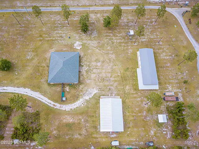 a view of a hallway with wooden floor and a bathroom